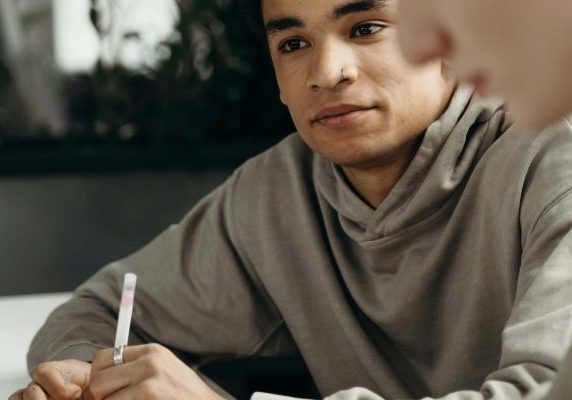A student listening attentively during a meeting or class.